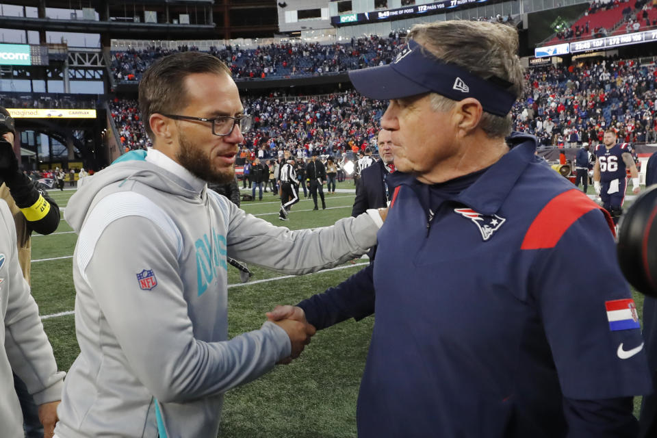 Miami Dolphins head coach Mike McDaniel, left, shakes hands with New England Patriots head coach Bill Belichick after an NFL football game, Sunday, Jan. 1, 2023, in Foxborough, Mass. The Patriots defeated the Dolphins 23-21. (AP Photo/Michael Dwyer)