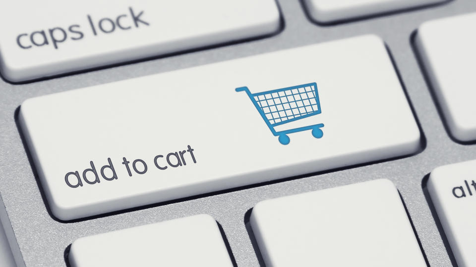 A computer keyboard button labeled add to cart with a picture of a shopping cart on it