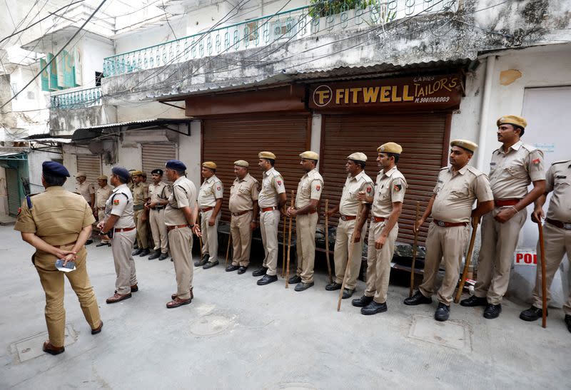 FILE PHOTO: Police stand next to the shop of Kanhaiyalal Teli, a Hindu tailor, in Udaipur
