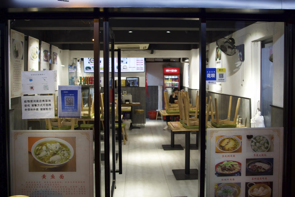 An empty restaurant offering only take out orders waits for customers in Shanghai, China, Tuesday, March 29, 2022. A two-phase lockdown of Shanghai's 26 million people is testing the limits of China's hard-line "zero-COVID" strategy, which is shaking markets far beyond the country's borders. (AP Photo/Chen Si)