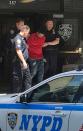 <p>A man, who police said was the suspected driver of a car which crashed into a crowd on Times Square, is led out of the NYPD Midtown South precinct in New York on May 18, 2017. (Rodrigo Campos/Reuters) </p>