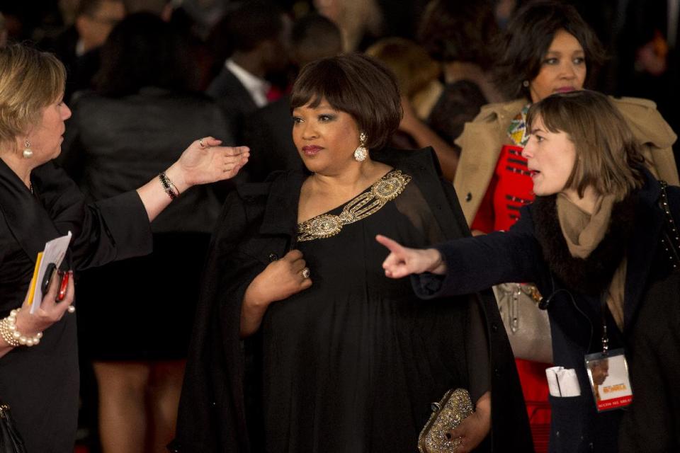 Zindzi Mandela, center, the daughter of Nelson Mandela arrives to attend the UK premiere of the movie "Mandela: Long Walk to Freedom" at a cinema in London, Thursday, Dec. 5, 2013. South African President Jacob Zuma announced later Thursday that former President Nelson Mandela has died aged 95, Zuma says "we've lost our greatest son." In the movie Idris Elba plays Nelson Mandela and Naomie Harris plays Winnie Mandela. (AP Photo/Matt Dunham)