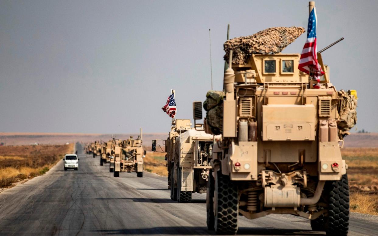 The first convoy of more than 70 vehicles left the Sarrin base on Sunday, headed for western Iraq - AFP