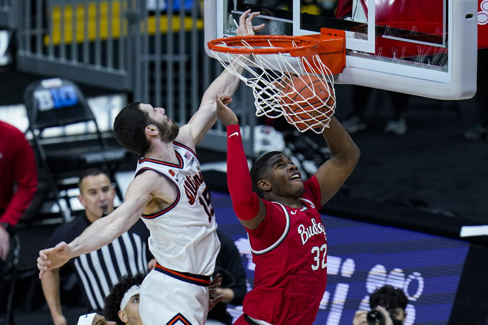 FILE - In this March 14, 2021, file photo, Ohio State forward E.J. Liddell (32) dunks in front of Illinois forward Giorgi Bezhanishvili (15) during the second half of an NCAA college basketball championship game at the Big Ten Conference tournament in Indianapolis. Ohio State opens on Nov. 9 against Akron, welcoming back fans to Value City Arena for the first time since 2019. (AP Photo/Michael Conroy, File)