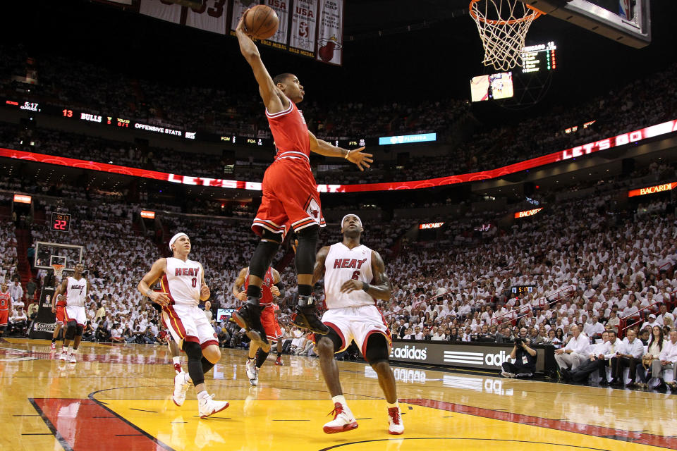 MIAMI, FL - MAY 24: Derrick Rose #1 of the Chicago Bulls dunks against LeBron James #6 and Mike Bibby #0 of the Miami Heat in Game Four of the Eastern Conference Finals during the 2011 NBA Playoffs on May 24, 2011 at American Airlines Arena in Miami, Florida. NOTE TO USER: User expressly acknowledges and agrees that, by downloading and or using this photograph, User is consenting to the terms and conditions of the Getty Images License Agreement. 