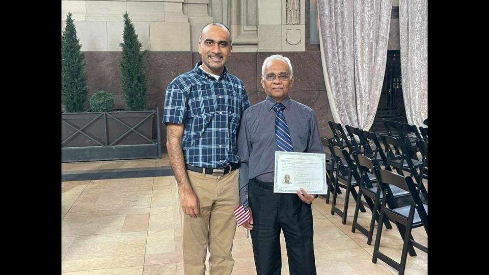 Bharat Tailor stood next to his son Bhavik after the Thursday ceremony, holding his certificate of citizenship.