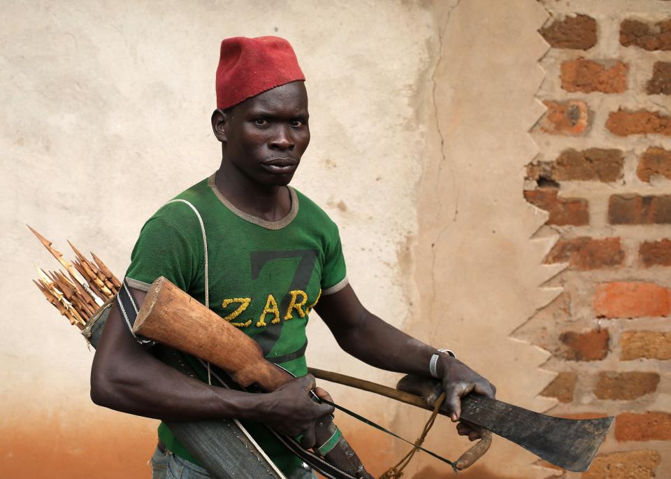 A member of the anti-balaka, a Christian militia, walks with his weapons in village of Zawa