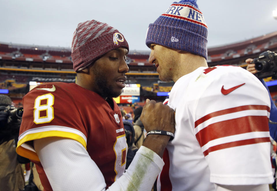 Washington Redskins quarterback Josh Johnson (8) talks with New York Giants quarterback Eli Manning, right, after an NFL football game Sunday, Dec. 9, 2018, in Landover, Md. (AP Photo/Patrick Semansky)