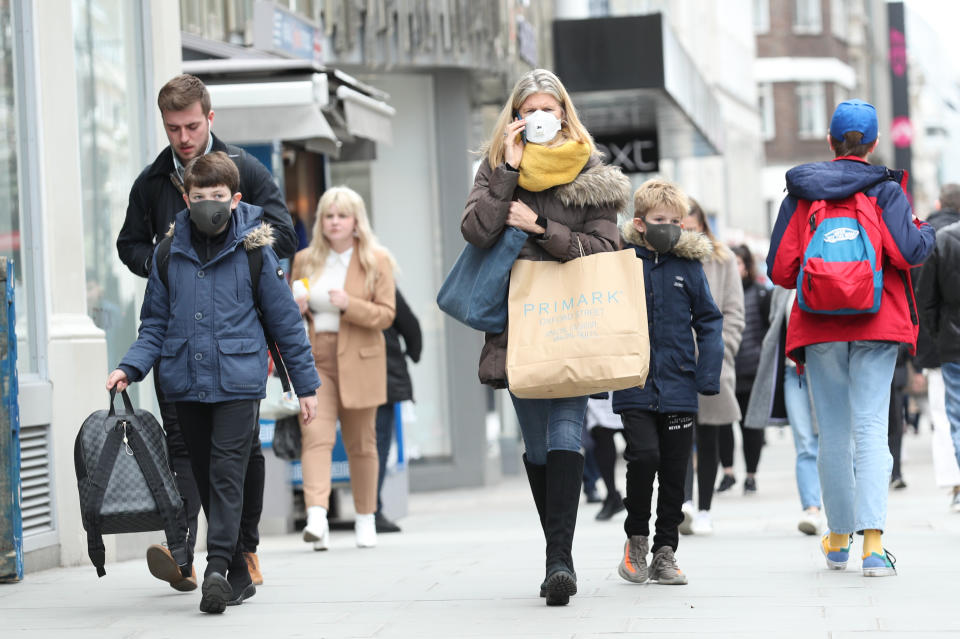 A woman wearing a protective face mask walking down Oxford Street in London, as the Government's top scientist warned that up to 10,000 people in the UK are already infected. (Photo by Yui Mok/PA Images via Getty Images)