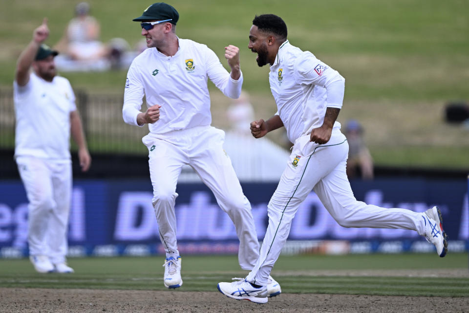 South Africa bowler Dane Piedt, right, celebrates after taking the wicket of New Zealand's Kane Williamson on the second day of their cricket test in Hamilton, New Zealand. Wednesday, Feb. 14, 2024. (Andrew Cornaga/Photosport via AP)