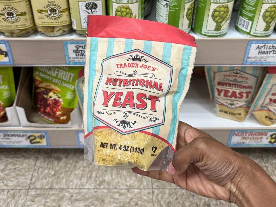 hand holding up a bag of nutritional yeast from trader joes