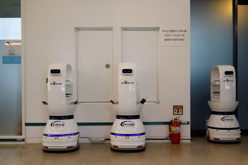 Robots that take orders, make coffee and bring the drinks straight to customers are charged in a cafe Daejeon