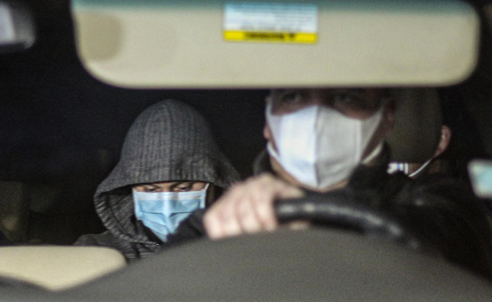 Nicolas Zepeda, left, is driven in a car by police investigators from his home where he was under house arrest, one day prior his extradition to France, in a Viña del Mar, Chile, Wednesday, July 22, 2020. Zepeda faces charges related to the 2016 murder of his former Japanese girlfriend Narumi Kurosaki. (AP Photo/Lucas Aguayo)