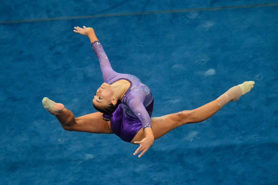 Olivia Dunne, seen here at a national competition in August 2018, practices her routine on the floor exercise during warm up period prior the first round of competition at TD Garden in Boston, Massachusetts. She is now on LSU's gymnastics team.