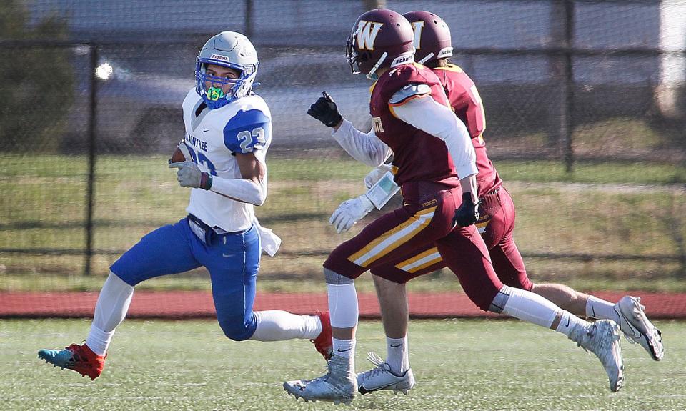 Wamps RB #23 Mario Franciosa Johnson outruns a pair of Weymouth defenders for a first down.Weymouth Wildcats host Braintree Wamps football on Wednesday April 14, 2021 Greg Derr/The Patriot Ledger