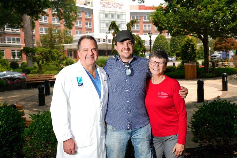 Ian Azeredo poses for a photograph with Dr. Louis DiFazio and an Emergency Department technician, at Morristown Medical Center.  Thursday, June 29, 2023