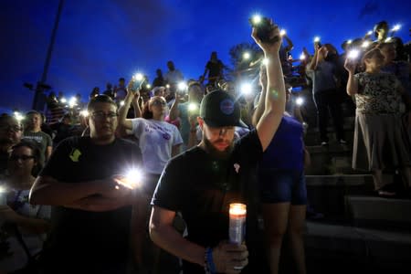 Mourners take part in a vigil at El Paso High School after a mass shooting at a Walmart store in El Paso