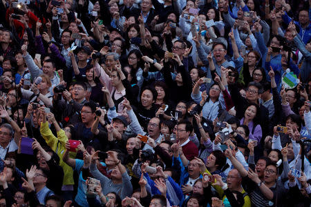 People attend an election campaign by candidate John Tsang, former Financial Secretary, at the financial Central district, two days before the Chief Executive election, in Hong Kong, China March 24, 2017. REUTERS/Bobby Yip