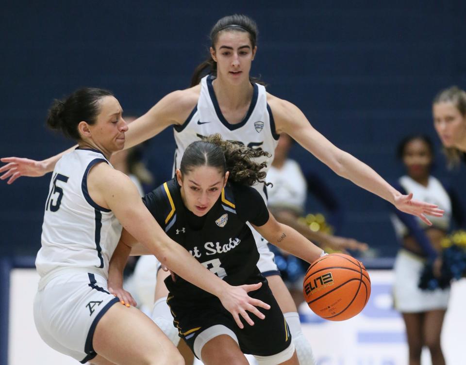 Akron's Morgan Haney and Reagan Bass pressure Kent State's Corynne Hauser in the first half, Saturday Jan. 20, 2024.