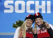 Gold medallists Canada's Kaillie Humphries and Heather Moyse (R)celebrate during the victory ceremony for women's bobsleigh at the Sochi 2014 Winter Olympic Games February 20, 2014. REUTERS/Eric Gaillard (RUSSIA - Tags: OLYMPICS SPORT BOBSLEIGH TPX IMAGES OF THE DAY)