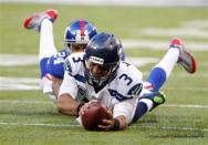 Dec 15, 2013; East Rutherford, NJ, USA; Seattle Seahawks quarterback Russell Wilson (3) dives forward for a first down as New York Giants cornerback Terrell Thomas (24) catches him from behind during the first half at MetLife Stadium. Mandatory Credit: Jim O'Connor-USA TODAY Sports