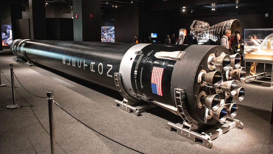 A black rocket displayed horizontally in an aviation museum