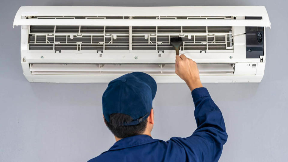 Man cleaning air conditioner