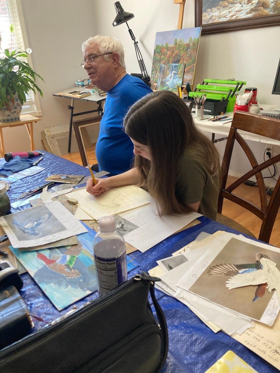 Aliyah Ridenour, 14, works on her Junior Duck Stamp Art Contest painting of a cinnamon teal with art instructor Greg Chappell.