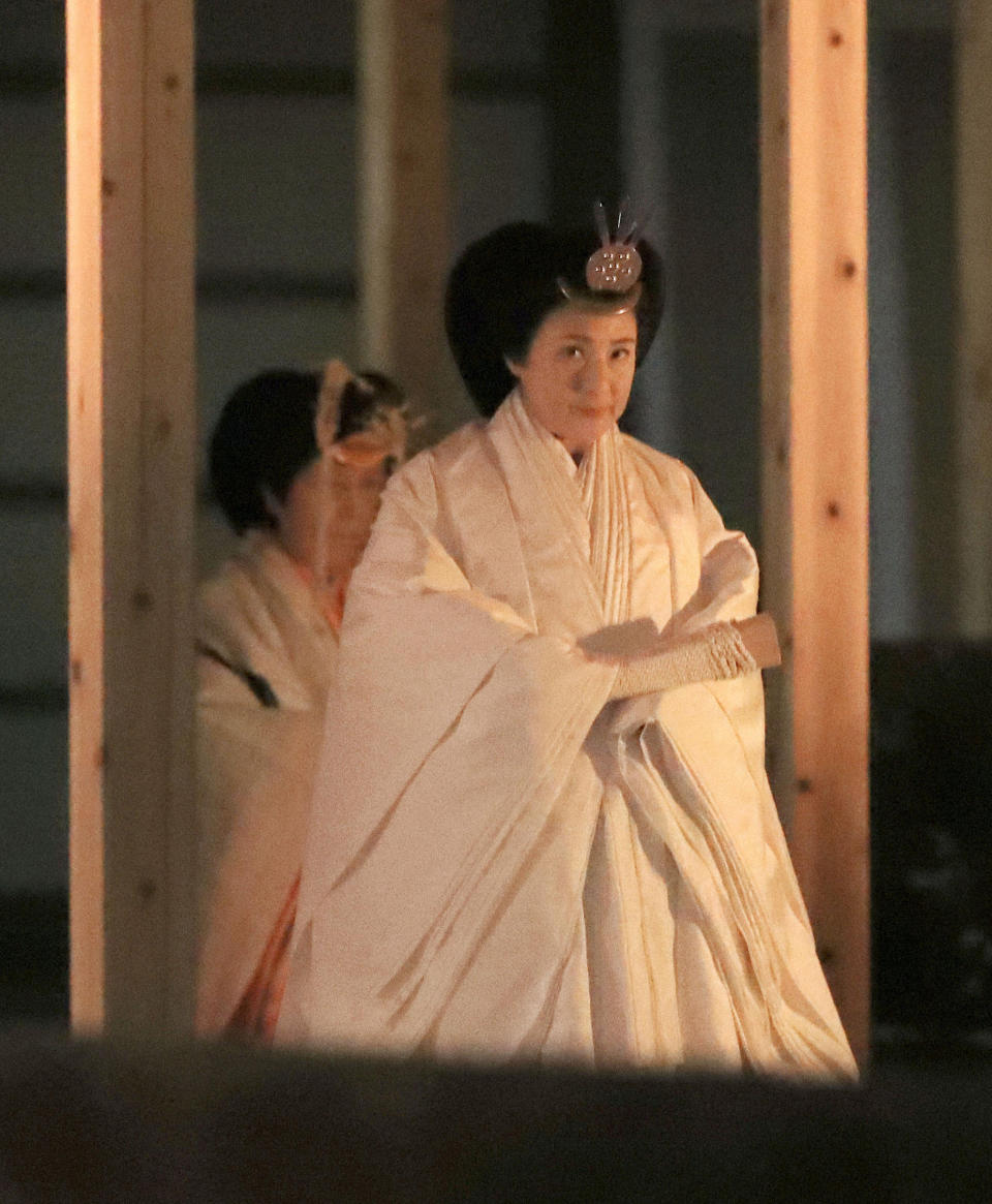 Japan's Empress Masako walks toward Yukiden, one of two main halls of the shrine, where Emperor Naruhito attends Daijosai, or great thanksgiving festival, at the Imperial Palace in Tokyo Thursday, Nov. 14, 2019. Naruhito performed a secretive and controversial ritual Thursday, a once-in-a-reign event to give thanks for good harvests, pray for the peace and safety of the nation and play host to his family’s ancestral gods. (Kyodo News via AP)