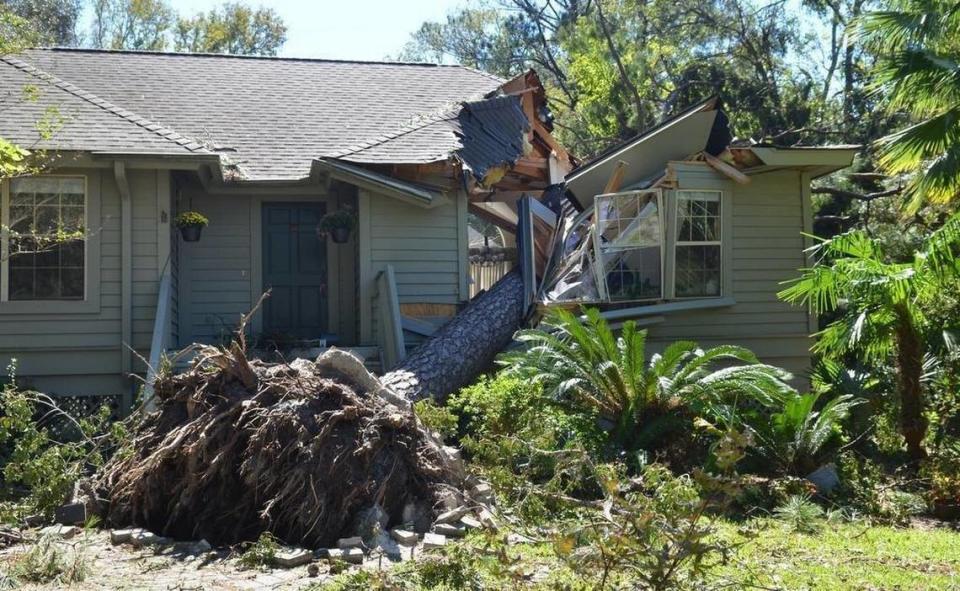 FILE: A fallen pine tree sliced through this Hilton Head Island home during Hurricane Matthew, which hit Hilton Head as a Category 2 storm in the early morning hours of Oct. 8, 2016.