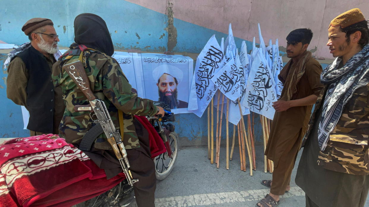 Members of Taliban forces gather and look at the picture of their leader Mullah Haibatullah Akhundzada, in Kabul. (Reuters)