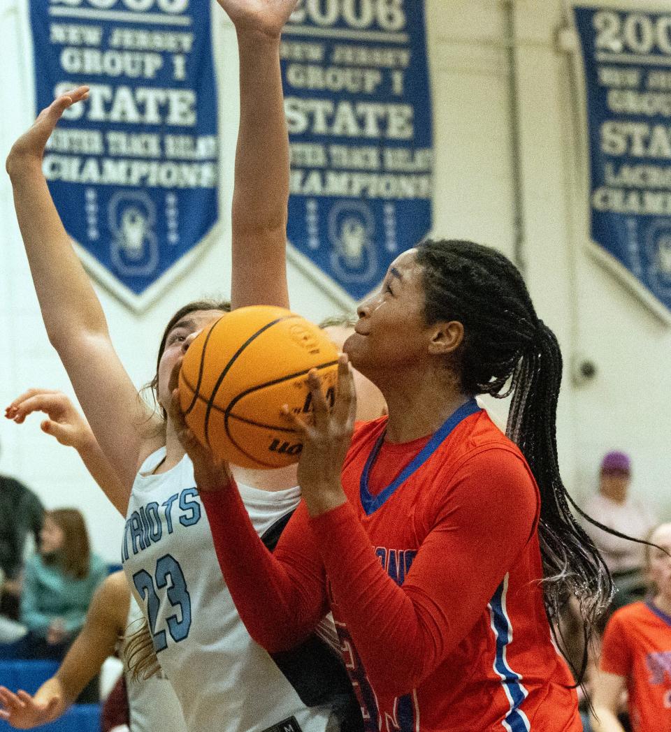Ocean Gamila Betton shoots as Freehold Madison Sciarrino tries to block her. Ocean Twp. Girls Basketball defeats Freehold Township in Blue Devil Holiday Invitational in West Long Branch on December 28, 2023.