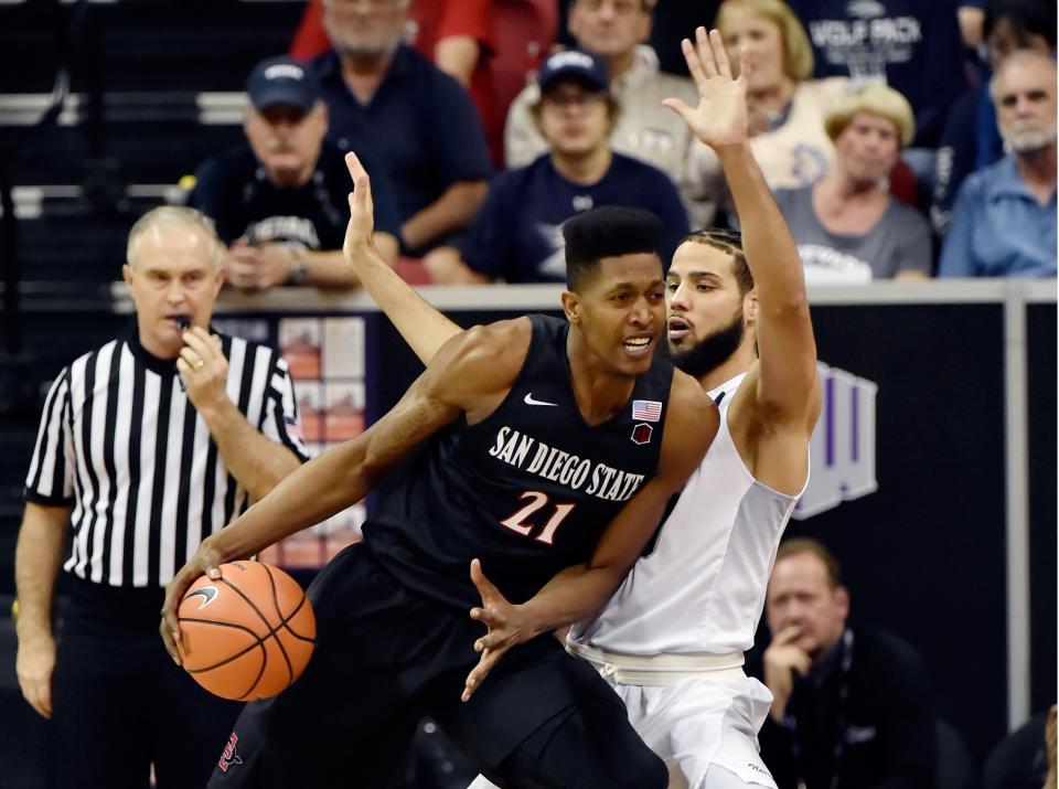 LAS VEGAS, NV – MARCH 09: Malik Pope #21 of the San Diego State Aztecs drives the ball against Caleb Martin #10 of the Nevada Wolf Pack during a semifinal game of the Mountain West Conference basketball tournament at the Thomas & Mack Center on March 9, 2018 in Las Vegas, Nevada. (Photo by David Becker/Getty Images)