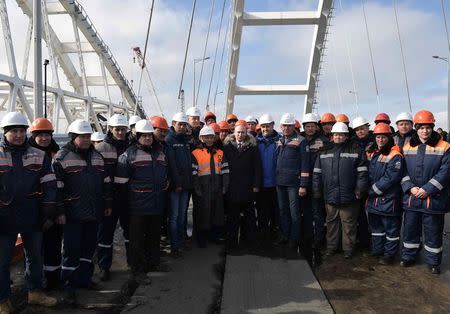 Russian President Vladimir Putin inspects the completed road section of the Crimea Bridge over the Kerch Strait, Crimea, March 14, 2018. Sputnik/Aleksey Nikolskyi/Kremlin via Reuters