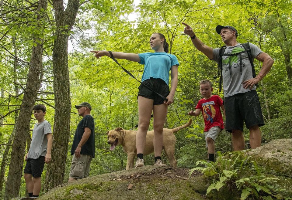 Hikers in a group decide which direction to go in Purgatory Chasm State Reservation in Sutton.