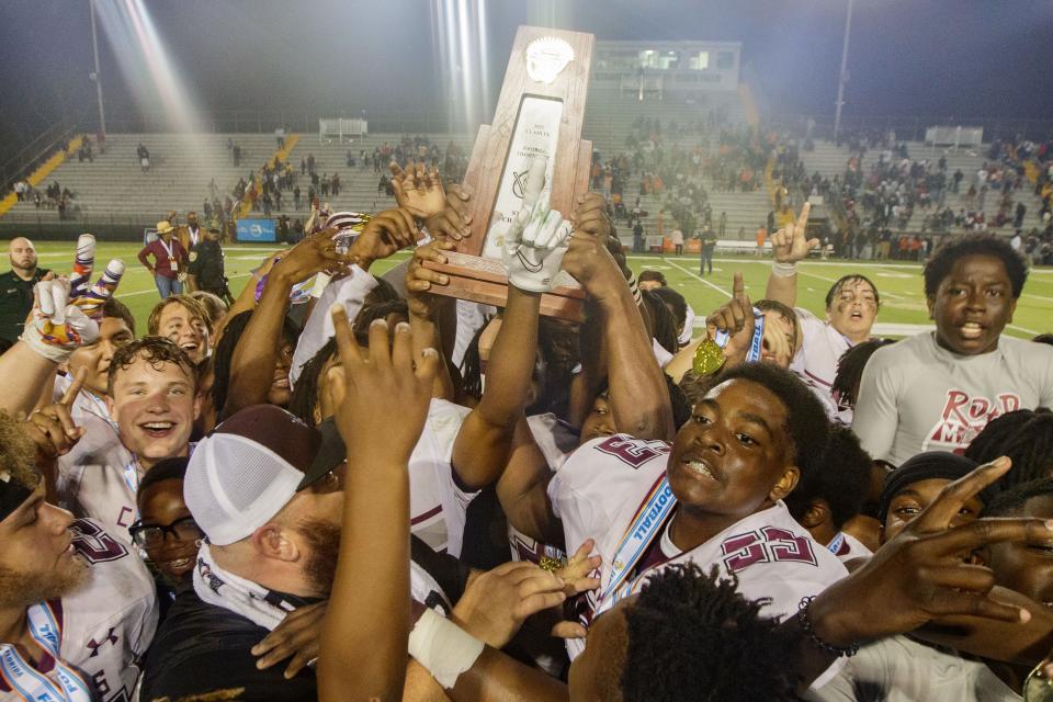 Madison County Cowboys celebrate their victory. Madison County defeated Hawthorne 13-12 to claim the Class 1A State Championship title at Gene Cox Stadium on Saturday, Dec. 11, 2021.