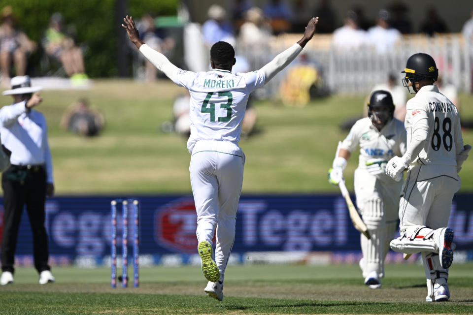 South Africa's Tshepo Moreki, center, celebratesafter taking the wicket of New Zealand's Devon Conway, right, during day 1 of their cricket test match in Mount Maunganui, New Zealand, Sunday Feb 4, 2024. (Andrew Cornaga/Photosport via AP)