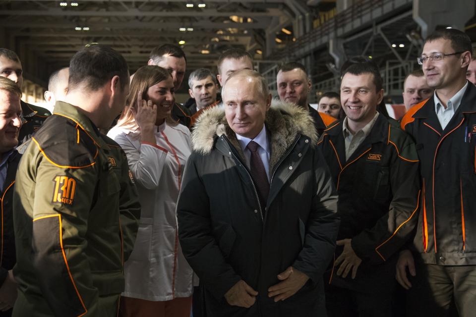 FILE - In this Tuesday, March 6, 2018 file photo, Russian President Vladimir Putin listens to employees of Uralvagonzavod factory in Nizhny Tagil, Russia. U.S. and European sanctions have restricted Russia’s access to international capital markets, limited imports of Western energy and military technologies and spooked international investors.(AP Photo/Alexander Zemlianichenko, File)