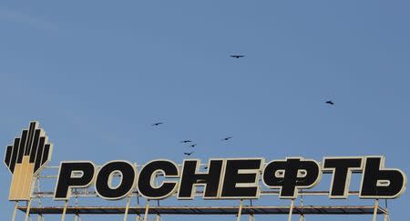 The logo of Russia's top crude producer Rosneft is seen on the top of a building in Stavropol, southern Russia, December 9, 2014. REUTERS/Eduard Korniyenko