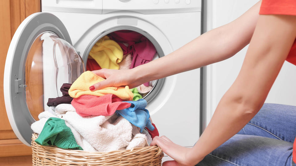 Loading a washing machine with colored clothes