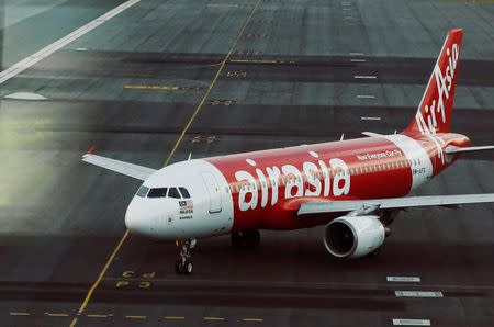 An AirAsia plane is seen on the runway at Kuala Lumpur International Airport August 19, 2014. . REUTERS/Olivia Harris