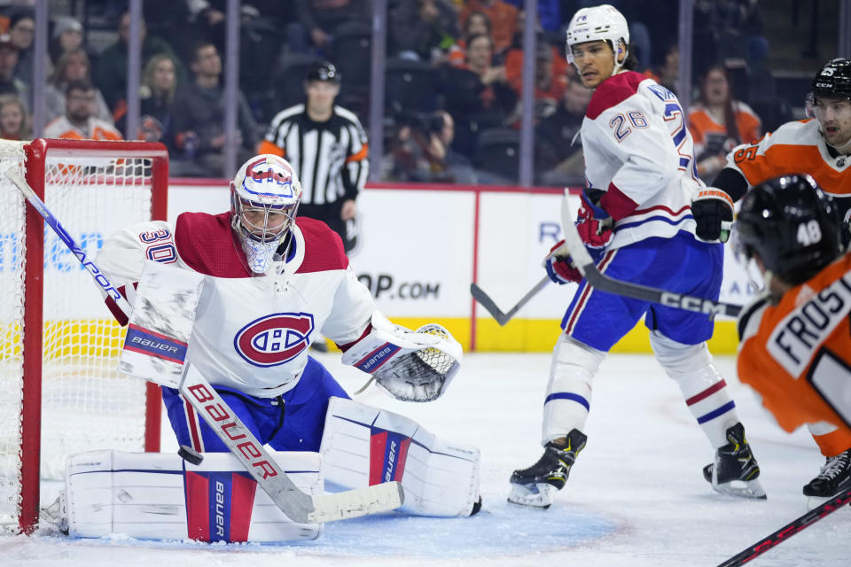 Montreal Canadiens' Cayden Primeau, left, cannot block a goal by Philadelphia Flyers' Morgan Frost, right, during the second period of an NHL hockey game, Tuesday, March 28, 2023, in Philadelphia. (AP Photo/Matt Slocum)