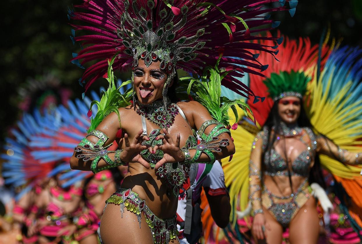 Performers take part in last year's Notting Hill Carnival: AFP/Getty