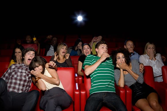 Full house at the movies. The audience is shocked at what's happening on the silver screen.