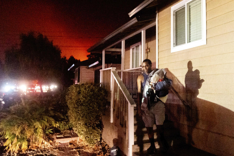 Image: Eddy Whitmore evacuates from his Santa Rosa, Calif., home as the Shady Fire approaches (Noah Berger / AP)