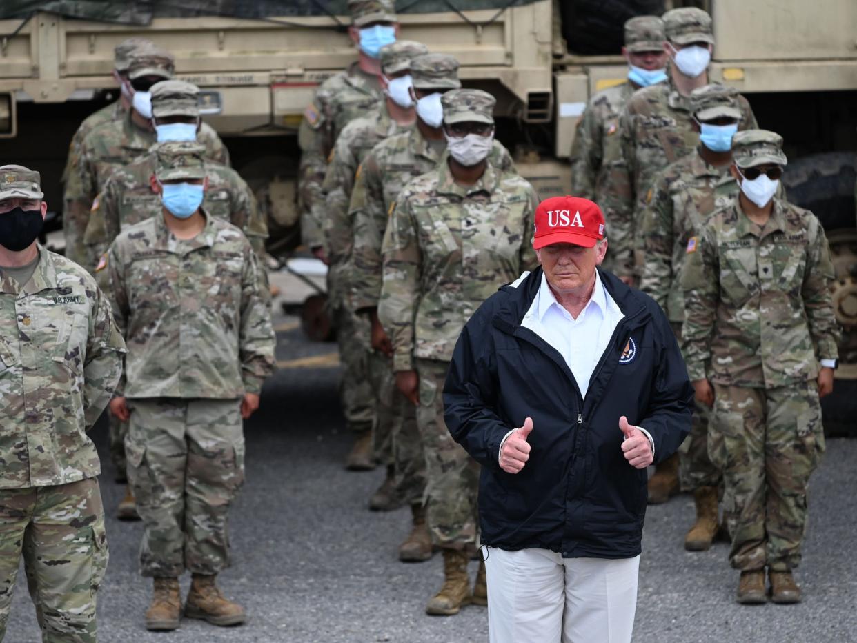 Donald Trump with National Guard troops in Lake Charles, Louisiana, on August 29, 2020 after Hurricane Laura tore through the area  (AFP)