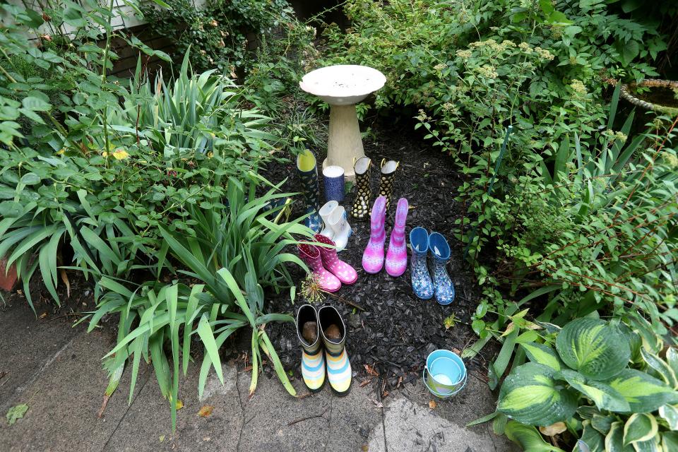 Rain boots are part of decoration in one of the backyard gardens. 