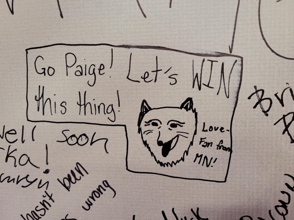 A fan signs the UConn Huskies poster, cheering on hometown Paige Bueckers. (Cassandra Negley/Yahoo Sports)