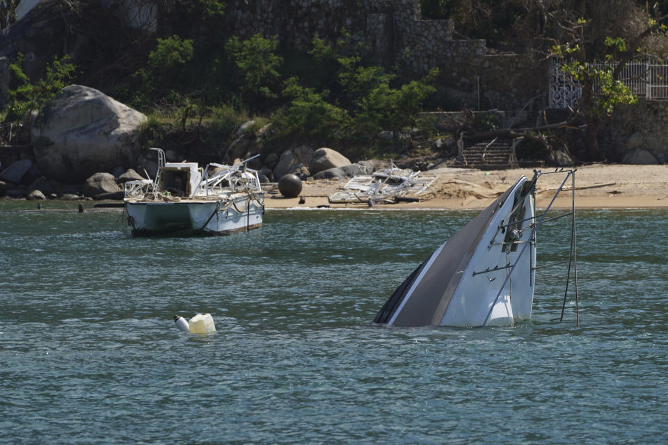 A boat is sunk after the passing of Hurricane Otis in Acapulco, Mexico, Saturday, Nov. 11, 2023. It was 12:20 a.m. on Oct. 25. when Hurricane Otis made landfall in this Pacific port city as a Category 5 hurricane, leaving 48 dead, mostly by drowning, and 31 missing, according to official figures. Sailors, fishermen and relatives of crew members believe that there may be more missing because sailors often go to take care of their yachts when a storm approaches. (AP Photo/Marco Ugarte)