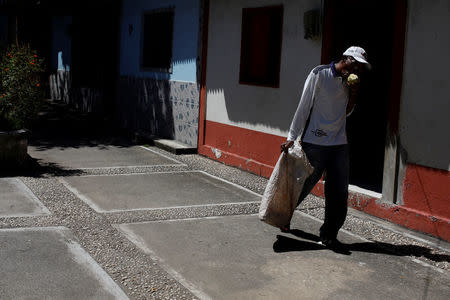 Yoffre Echarri eats from a cocoa pod as he walks close to his house in Caruao, Venezuela October 24, 2017. REUTERS/Carlos Garcia Rawlins